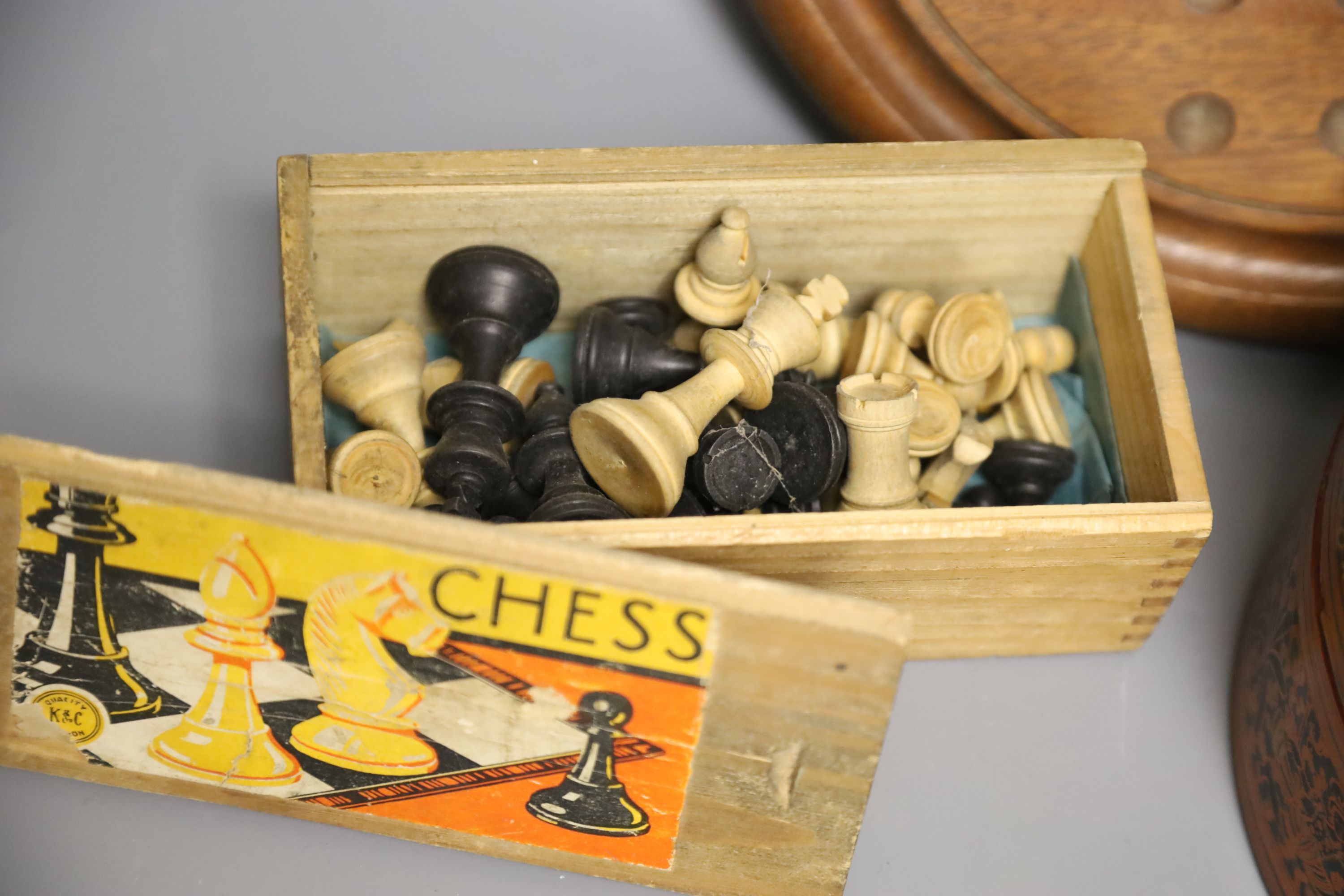 A quantity of marbles, boxwood chess pieces, a solitaire board and bone scrabble pieces and counters